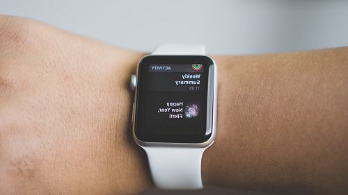 person wearing silver aluminum case Apple Watch with white Sport Band
